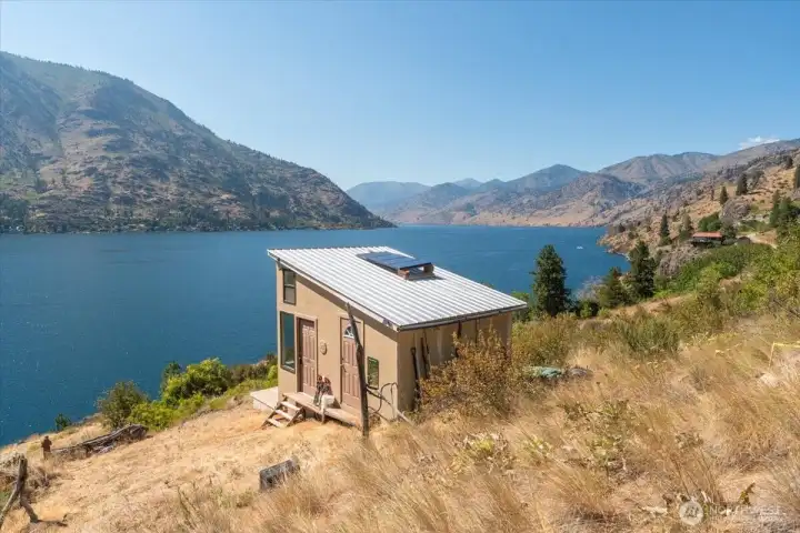 View of cabin and lake