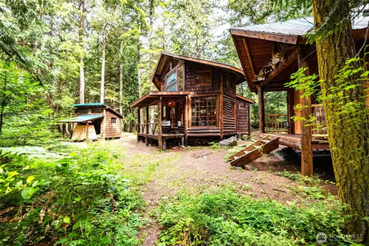 Main cabin, shop and golf cart carport and bunkhouse to the right