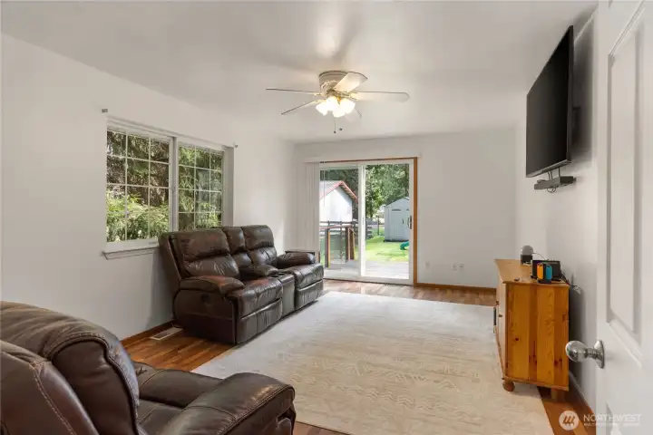 Family room with slider leading to sideyard and the hot tub