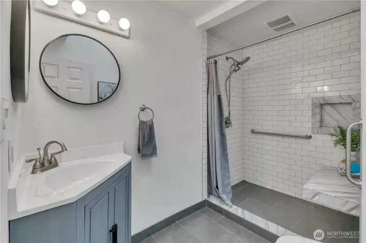 Large bathroom with walk-in shower and skylight