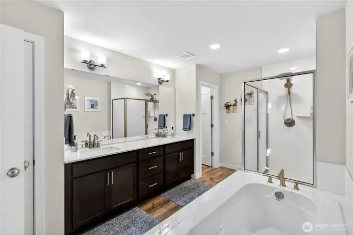 Primary bath boasts dual vanities, built in makeup station, soaking tub and separate shower.