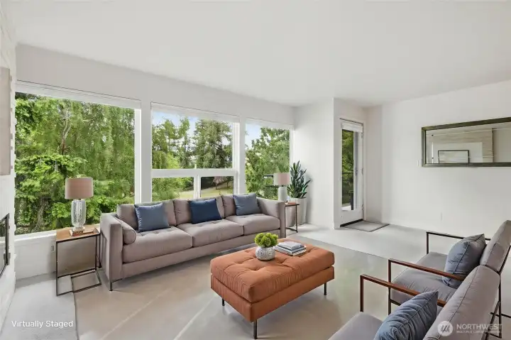 Virtually staged photo of living room looking toward the large windows