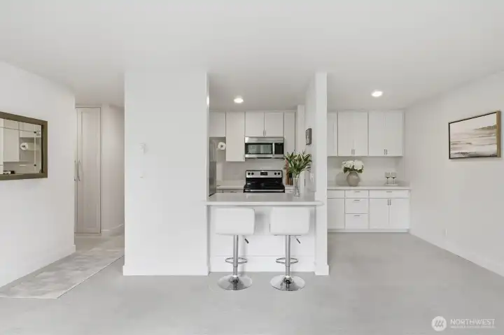 View of kitchen from Living room showing eat in bar