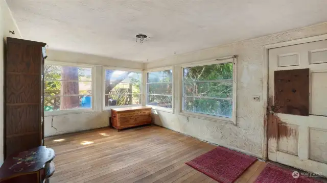 Wall of windows in this living space brings tons of natural light, allowing you to truly see all the potential this home has to offer.