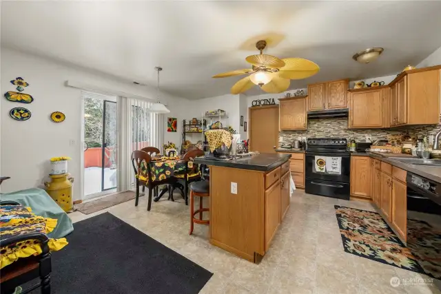 Kitchen comes with glass-tiled backsplash and quartz counters.