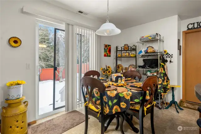 Eat-in area of the kitchen, showing the slider to the fenced backyard.