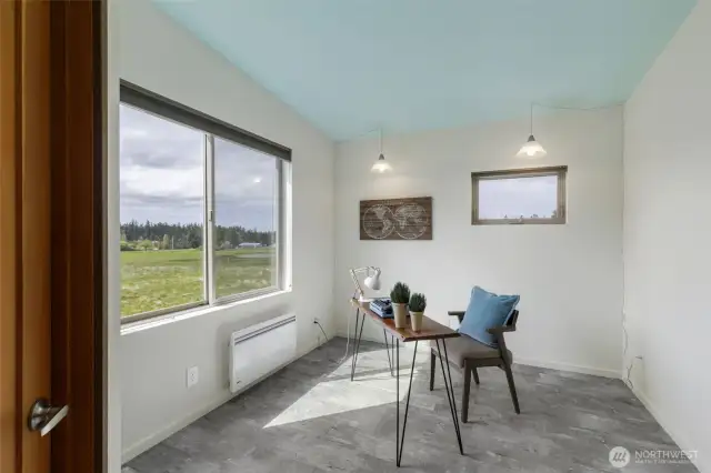 Light-filled office or guest bedroom with views of peaceful meadows.