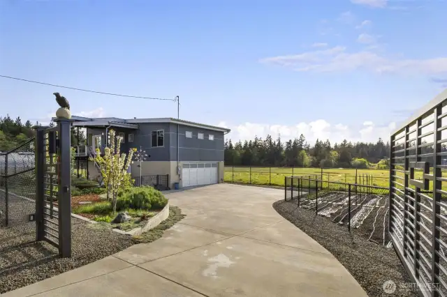 A private gated entrance welcomes you to a stunning home and beautifully landscaped grounds.