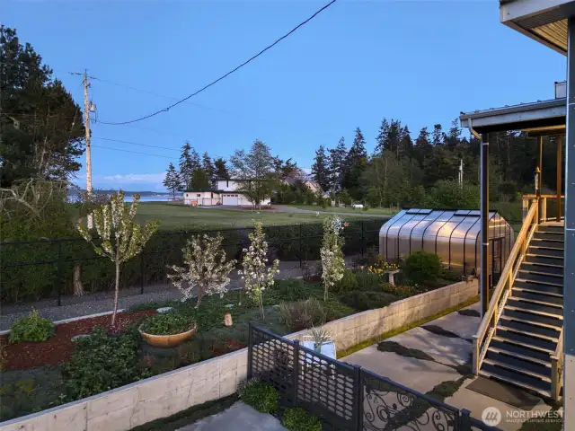 Blooming orchard trees and raised beds offer a lush and functional retreat.