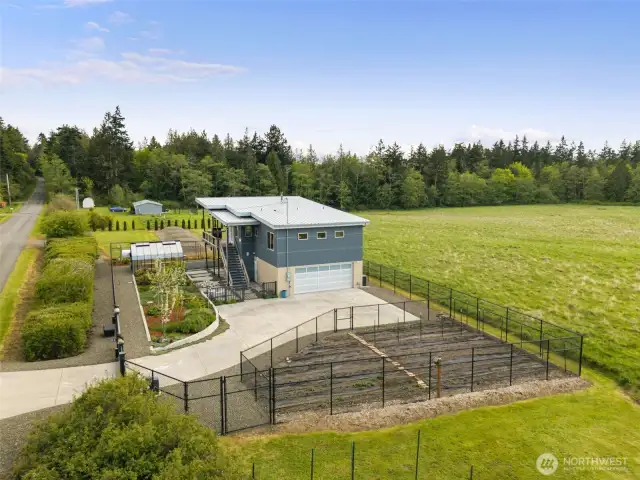 Aerial perspective reveals the modern home’s elegant footprint and private rural setting.