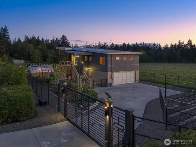 Nightfall highlights the gated entry and soft exterior lighting for added charm.