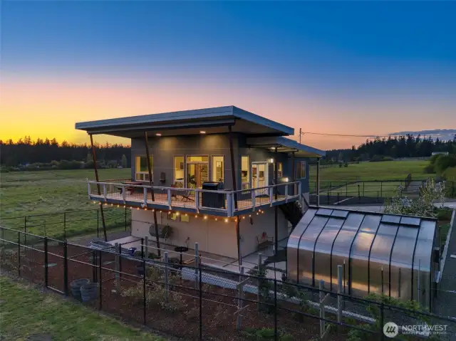 Evening tranquility surrounds the home, perfect for stargazing or relaxing on the deck.