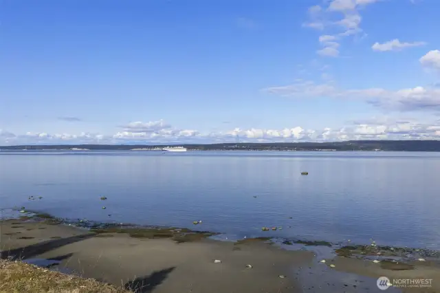 Peaceful shoreline with calm waters and panoramic views.