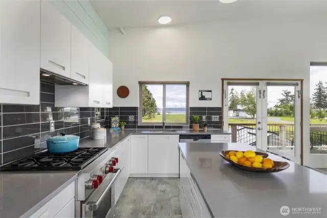 A chef’s dream—this bright, modern kitchen features a dual fuel Wolf range and inspiring views, perfect for cooking and gathering.