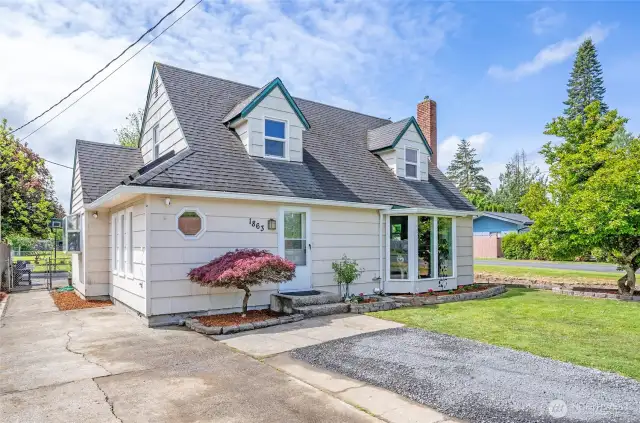Charming Cape Cod-style home in Chehalis’ desirable Snively district, featuring a manicured lawn, updated windows, fresh landscaping, and classic dormer windows that give it timeless curb appeal. The large bay window and brick chimney add warmth and character.