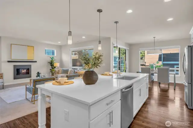 Massive 10ft quartz island separating the kitchen from the living space.
