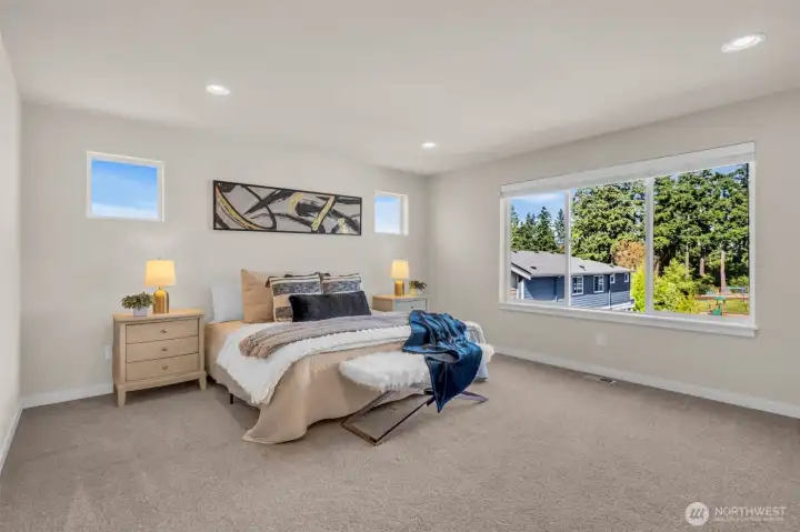 Sprawling primary bedroom with large east facing view for morning sun.