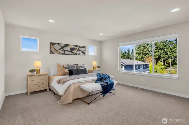 Sprawling primary bedroom with large east facing view for morning sun.