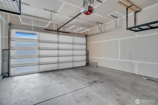Oversized double car garage with ceiling storage.