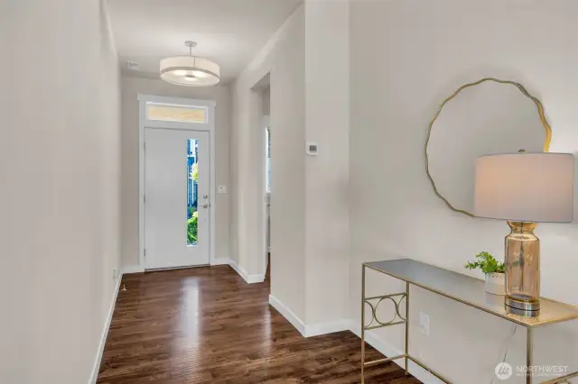 Entrance to the home with powder room and coat closet off to the side.