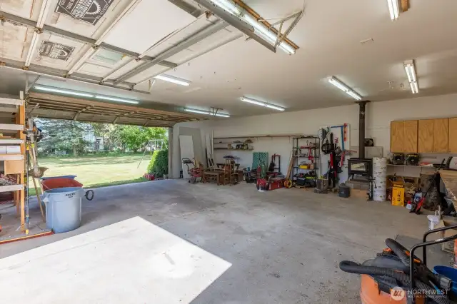 Interior shot of shop. Shop has two roll-up doors, and working wood stove.