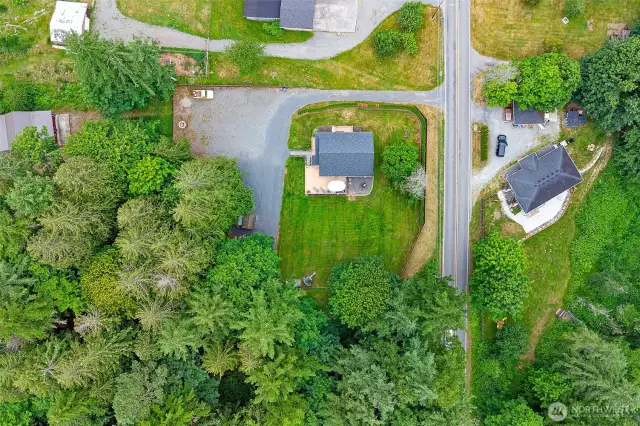 Bird’s-eye view highlighting the well-maintained 0.67-acre property with mature trees, spacious yard, and private driveway—offering peace, privacy, and easy access to the main road.