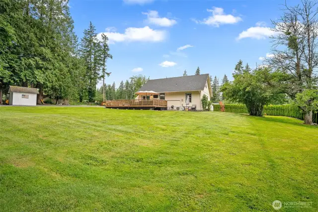 ChatGPT said:  Expansive backyard with lush lawn, mature trees, and a large entertainment deck—perfect for gatherings, gardening, or simply enjoying the tranquility of this private retreat.