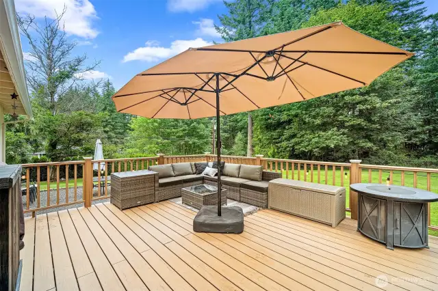 Enjoy serene outdoor living on this beautifully finished deck all surrounded by peaceful greenery.