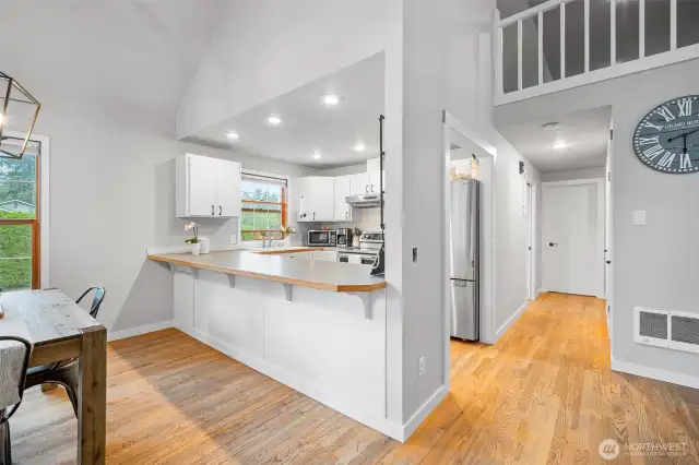 Bright and functional kitchen with white cabinetry and a spacious breakfast bar—perfect for casual dining and entertaining.