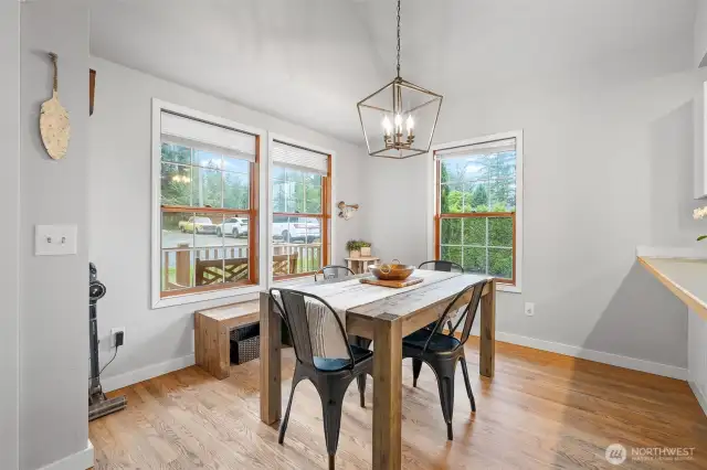 Inviting dining area with abundant natural light, vaulted ceilings, and rustic charm—perfect for cozy meals or casual entertaining.