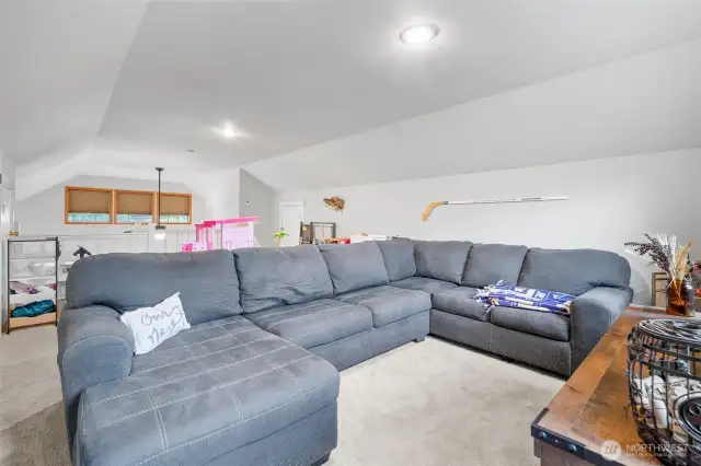 Spacious upstairs loft featuring plush carpeting, abundant storage, and plenty of space for relaxing or play.