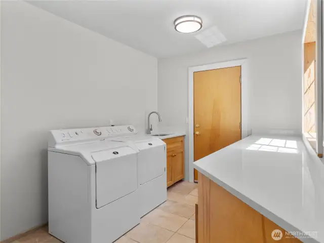 Main floor laundry room features storage