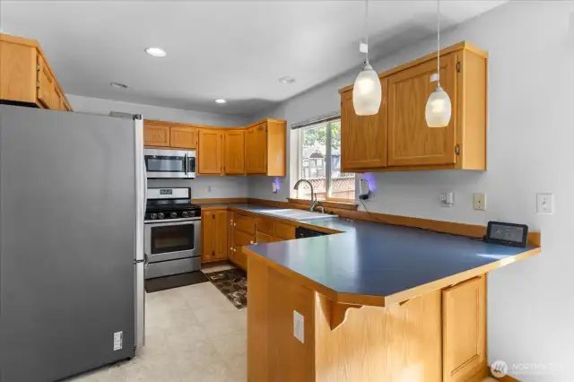 Large kitchen with tons of storage & eating bar.