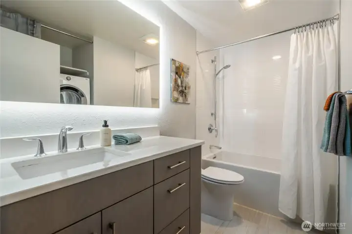 Main Bathroom with Tub Shower Combo. Floating Vanity and Modern Tile.