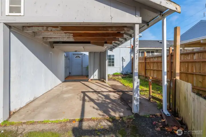 Two-unit townhouse, with separate covered carport and driveway.