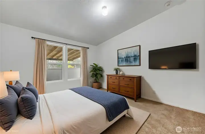 The virtually staged bedroom #2, with vaulted ceilings.