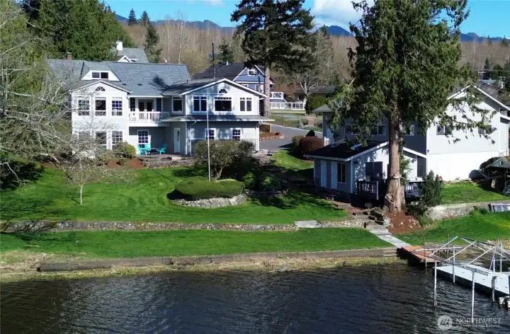 Luxury Meets Lakefront Living on Big Lake - Located just one hour from Seattle and 90 minutes from Vancouver, B.C.  Experience the perfect blend of historic charm and modern luxury at this fantastic waterfront estate. Situated on nearly one acre of low-bank frontage, this classic Cape Cod-style home offers 198 feet of private shoreline, complete with a dock, boat lift, jet ski ramp, slide and a lake side gazebo with kitchen/bath -located just steps from the water for endless summer fun.