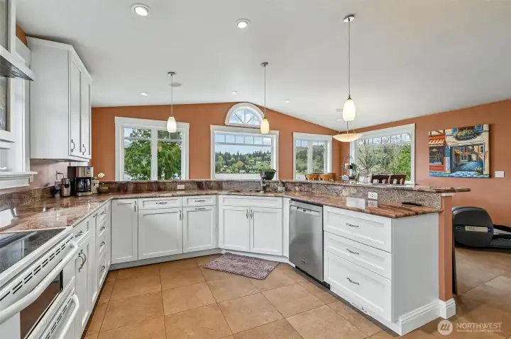 Spacious kitchen offers abundant workspace with beautiful granite counters. Two separate sinks and a circulating pump for instant hot water.