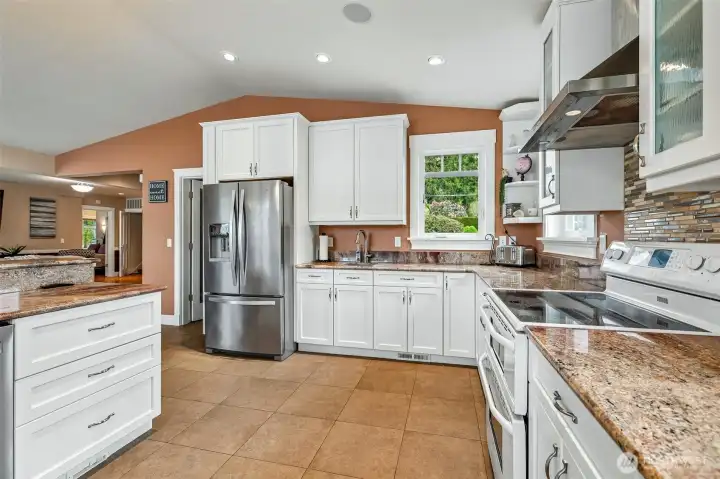 Custom soft close cabinetry with pull-out shelving. Warming drawer & separate bar sink. Large walk-in pantry with ample storage.