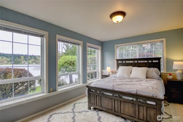 Lower level Bedroom #4 with lake views. This bedroom has access to lake view patio with wiring for future hot tub. This room also has a large walk in closet or could be used as a flex space.