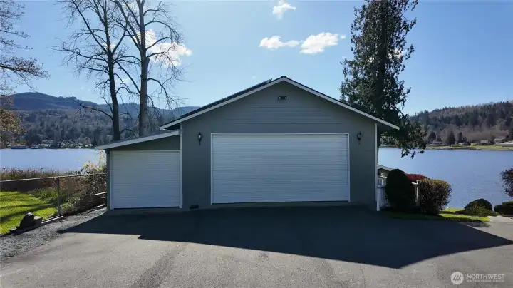 An expansive 40’x38’ shop offers plenty of covered storage of vehicles, boats & water toys and a workshop with a wood stove. Plus there is an attached two-car garage on the home.