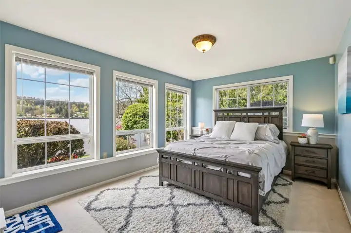 Lower level Bedroom #5 with lake views. This bedroom has access to lake view patio with wiring for future hot tub. This room also has a large walk in closet or could be used as a flex space.