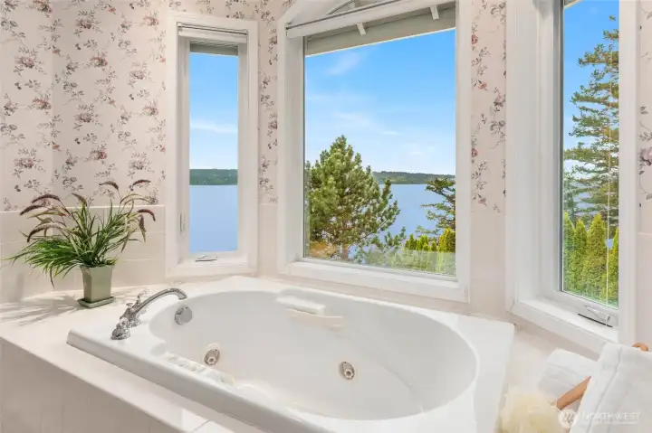 Jetted Soaking Tub with Windows Framing the Water Views