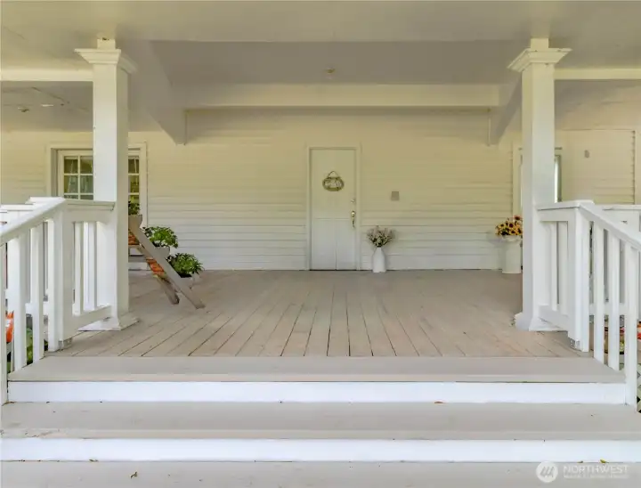Expansive covered front porch creates a warm and inviting welcome.