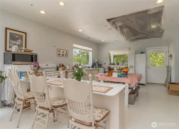 Spacious kitchen featuring two large windows that fill the space with natural light while offering beautiful views.