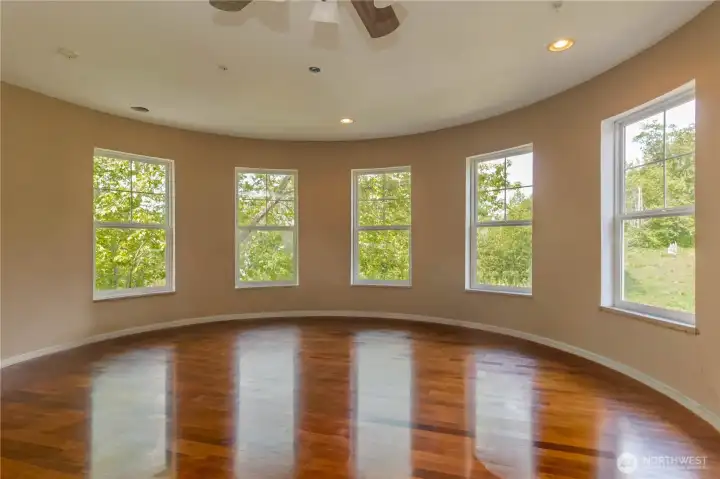 Second-floor rounded bonus room, a unique space ideal for a second den, office, or creative retreat.
