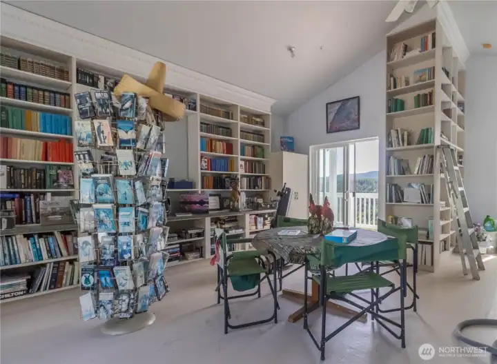 Third-floor bonus room currently used as a library, featuring easy access to two private decks on either side.