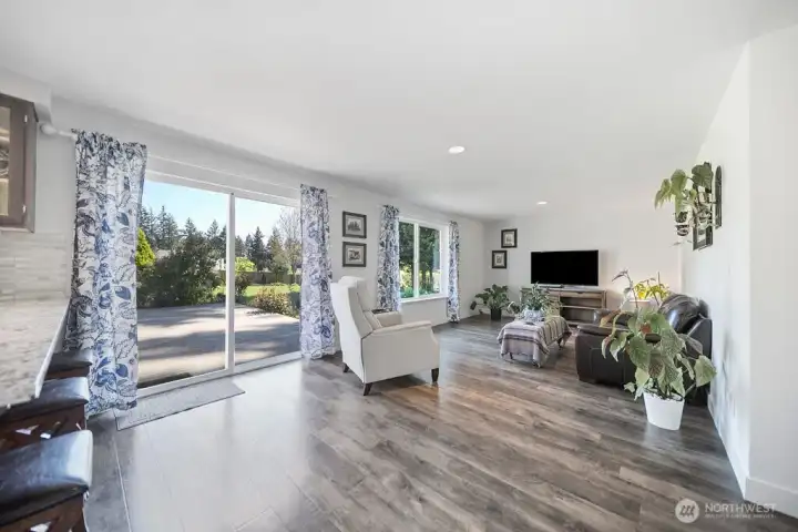 Open concept kitchen and living area that open to back patio