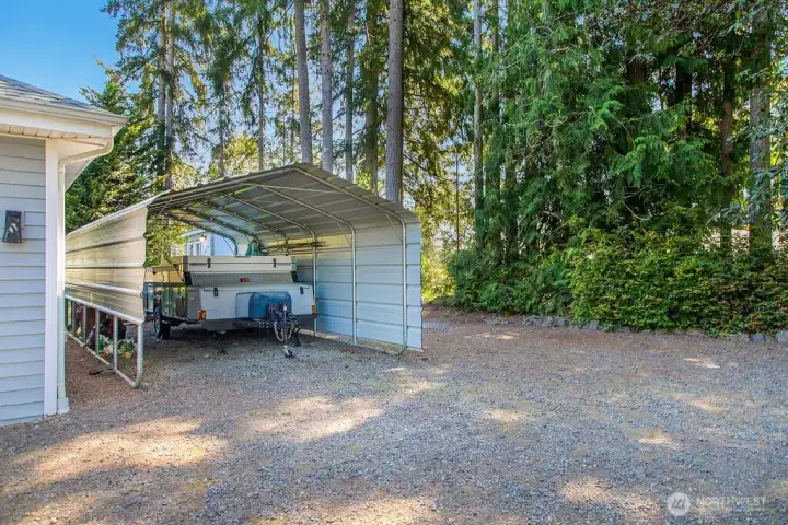 Covered RV Parking and generous gravel space for extra parking
