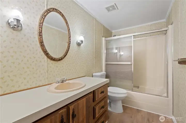 FULL HALL BATH with Tub/Shower Combo and long vanity. Newer Laminate Floors.